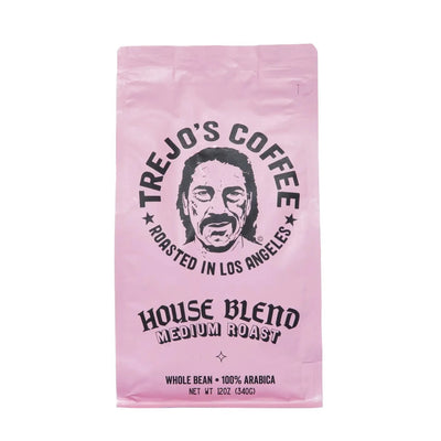 pink pouch of coffee with black branded lettering featuring an illustration of Danny Trejos.