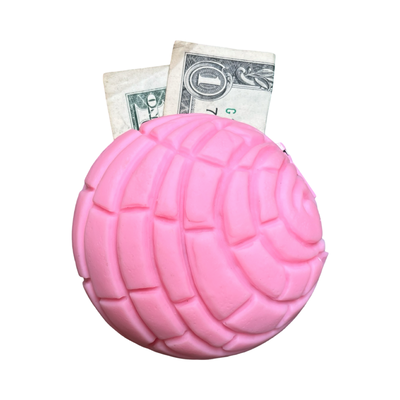 round rubber pink concha coin purse with a dollar bill