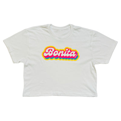 white crop top with the phrase Bonita in pink, yellow and blue lettering.