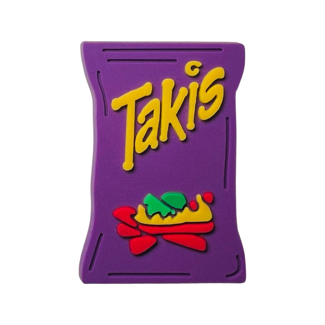 Purple chancla, or croc, charm with the word takis in yellow lettering.