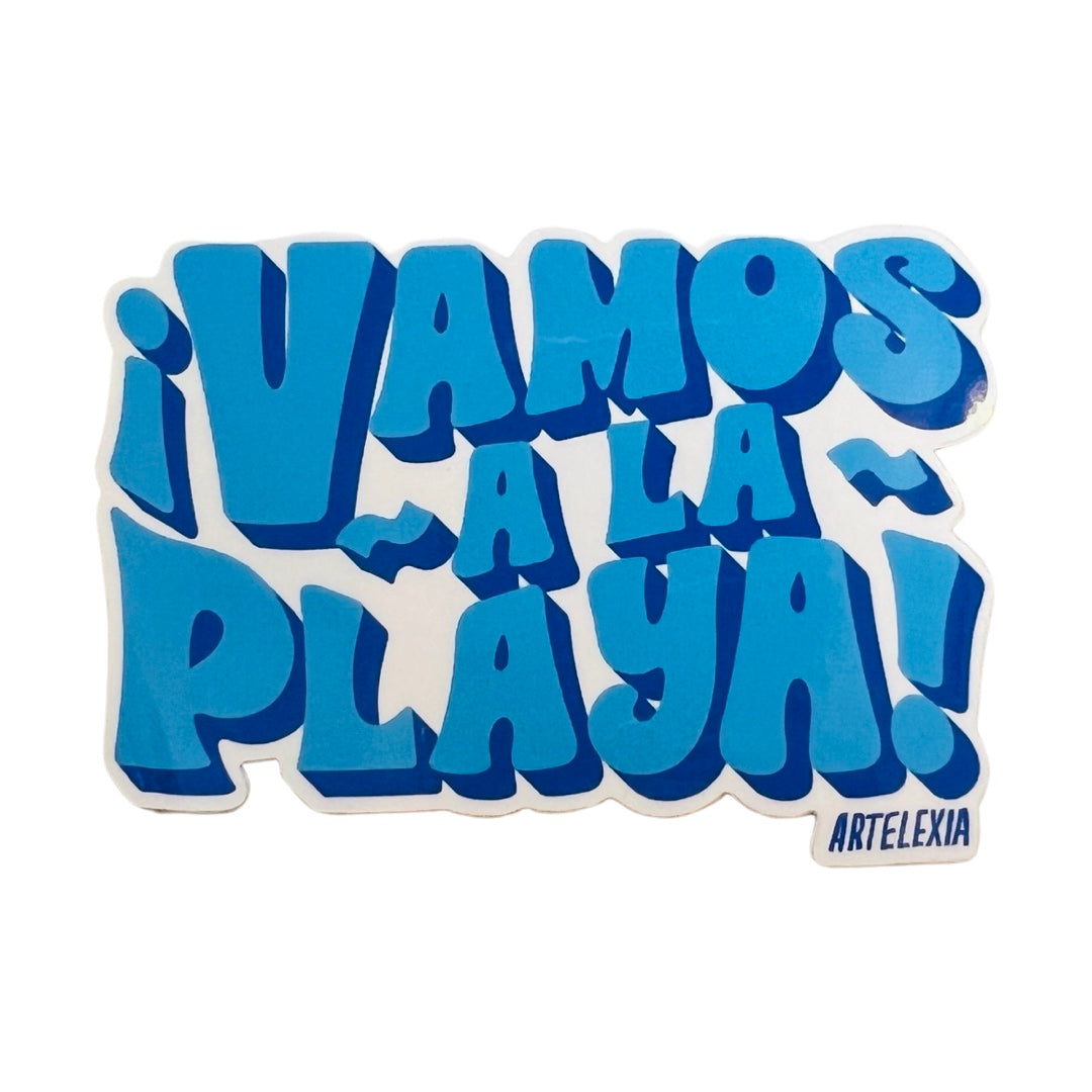 White sticker with the phrase Vamos A La Playa in blue bubble lettering