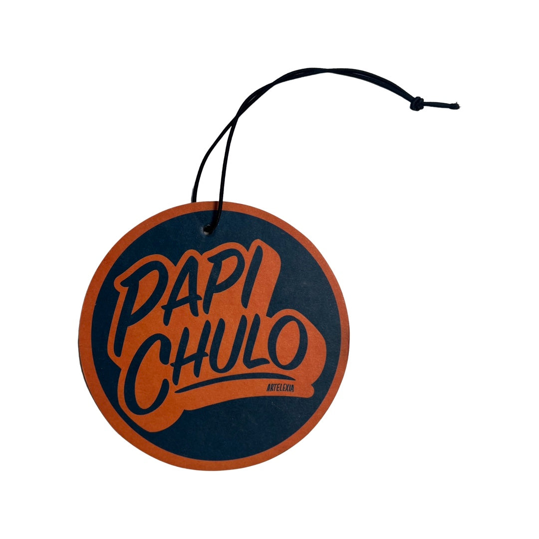 Navy blue round freshener with an orange border and the phrase Papi Chulo in Orange and Navy blue lettering.