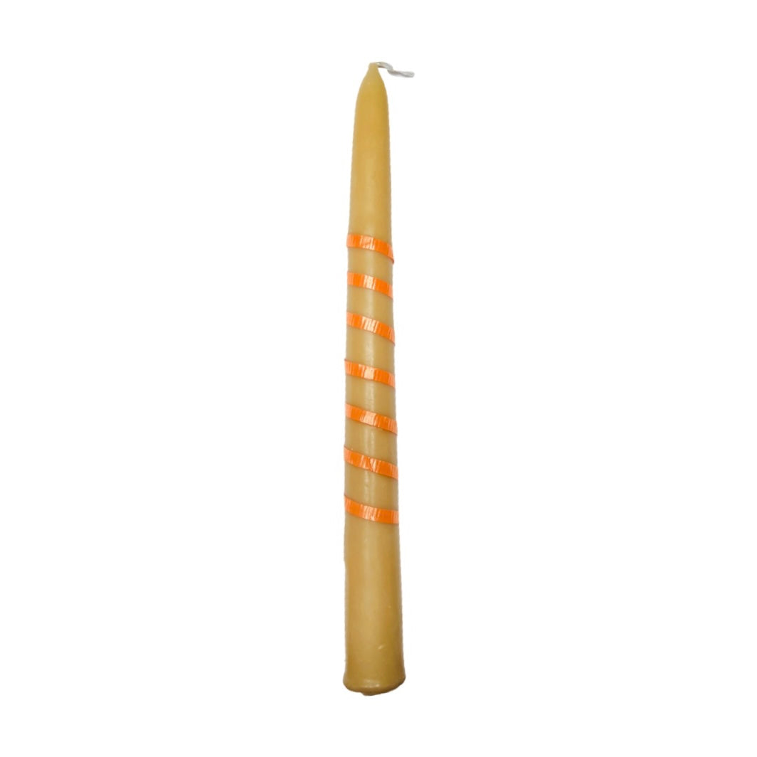 Cream colored candlestick wrapped with an orange ribbon