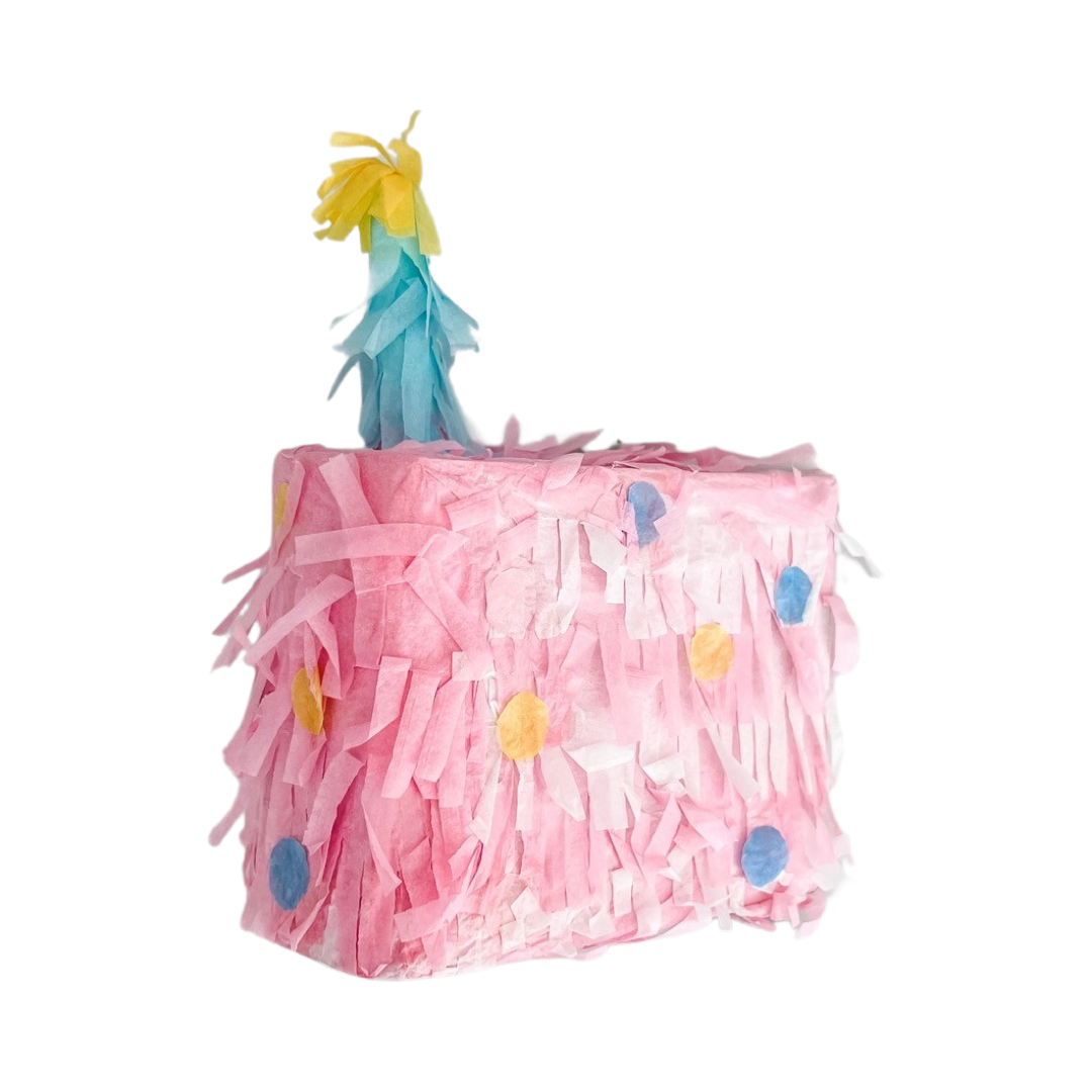 pink piñata with a blue candle and colorful confetti