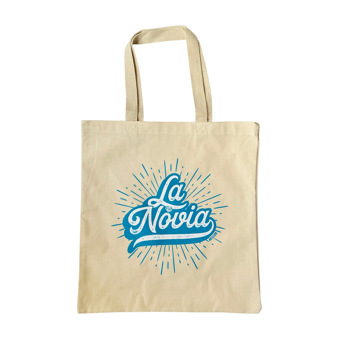 Natural canvas tote bag with the phrase La Novia in blue and white lettering featuring a ring in the place of the "O."