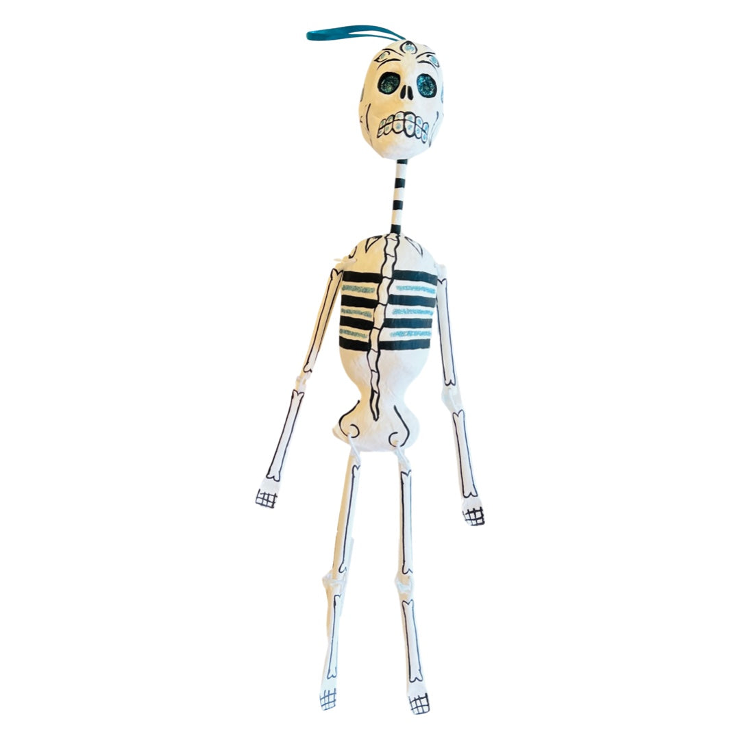 Paper mache full body skeleton with glitter in its eyes and rib cage.