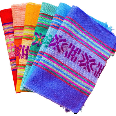 Mexican Servilletas in a variety of colors and patterns. Colors featured: red, orange, yellow, green, blue, and purple. 