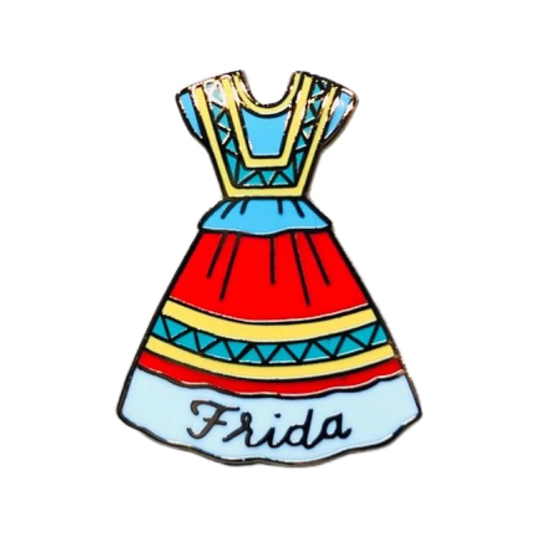 Frida Kahlo dress enamel pin. Blue, red, yellow, & white patterend dress with Frida's name (cursive font) on the bottom. 