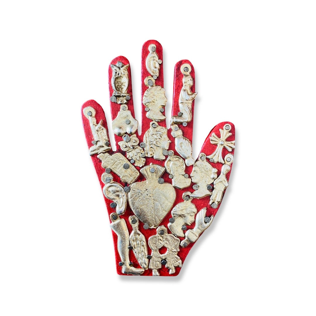 Handmade wooden milagro hand in red. Design features a variety of mini milagro charms.