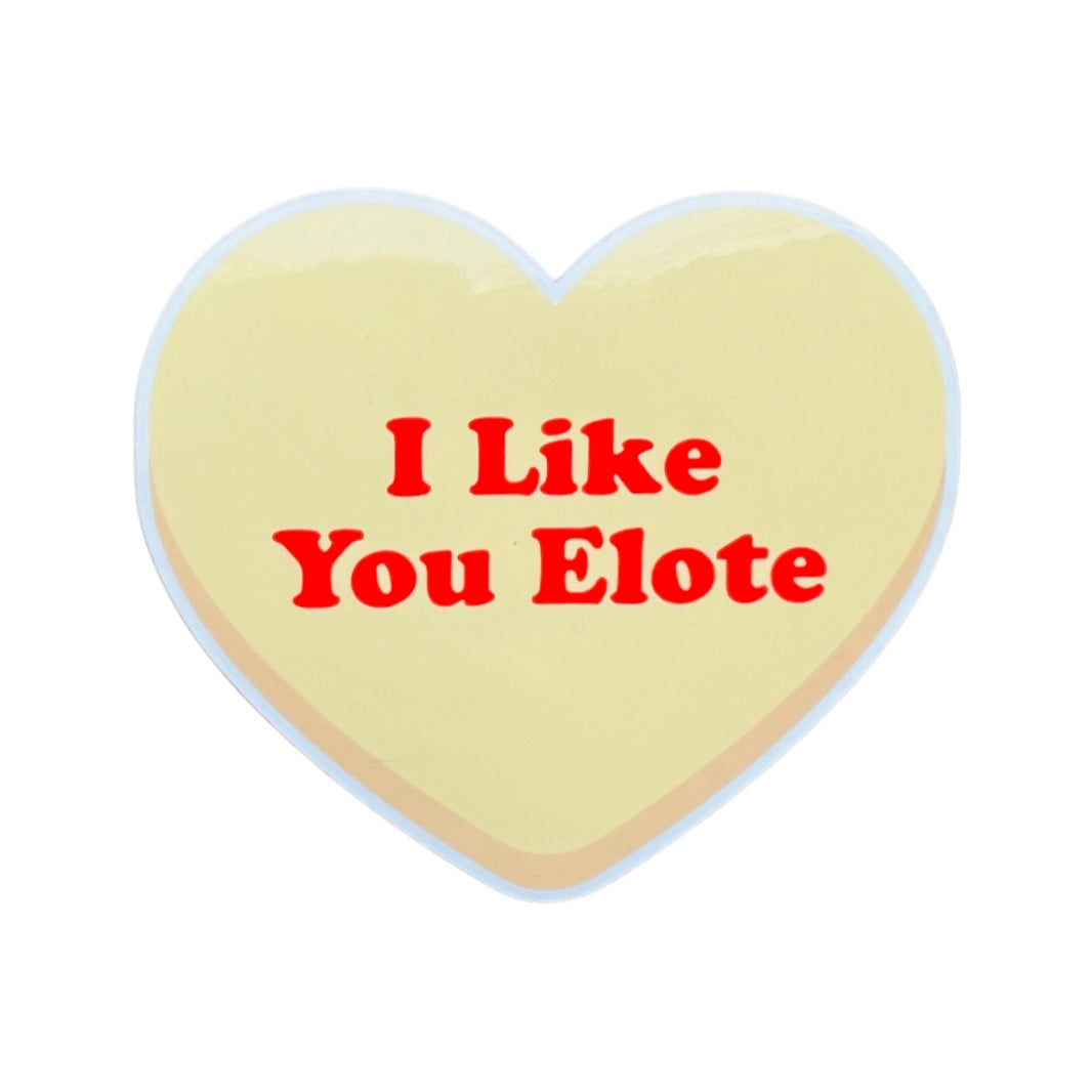 Yellow heart with the phrase I Like You Elote in red lettering