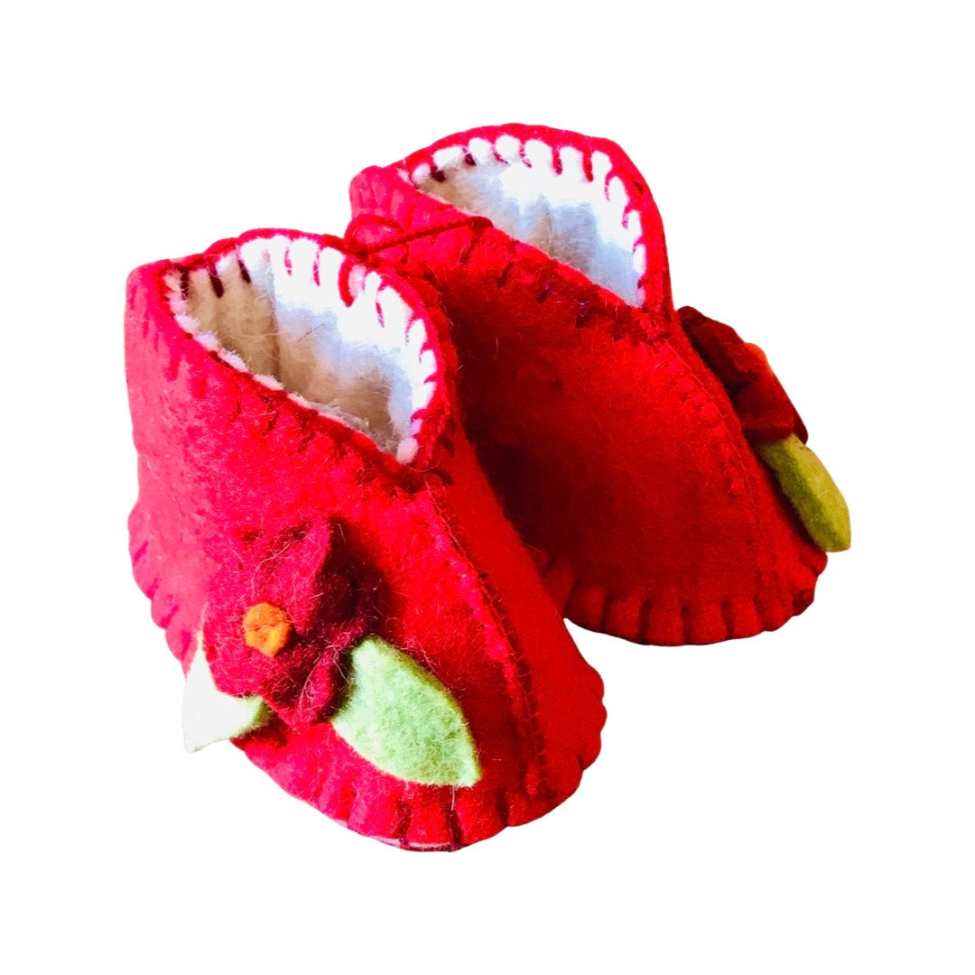 Red wool booties with a red flower attached to the side of each.