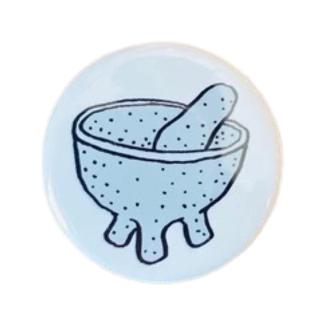 White round pin button with an image of a molcajete