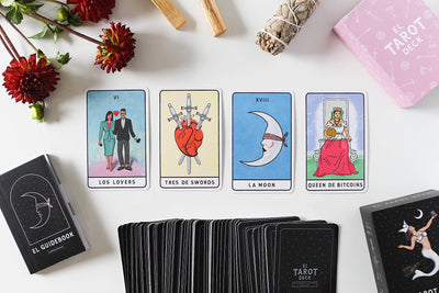 Photo of four tarot cards including "Los Lovers", "Tres de swords", "La Moon" and "Queen de Bitcoins"