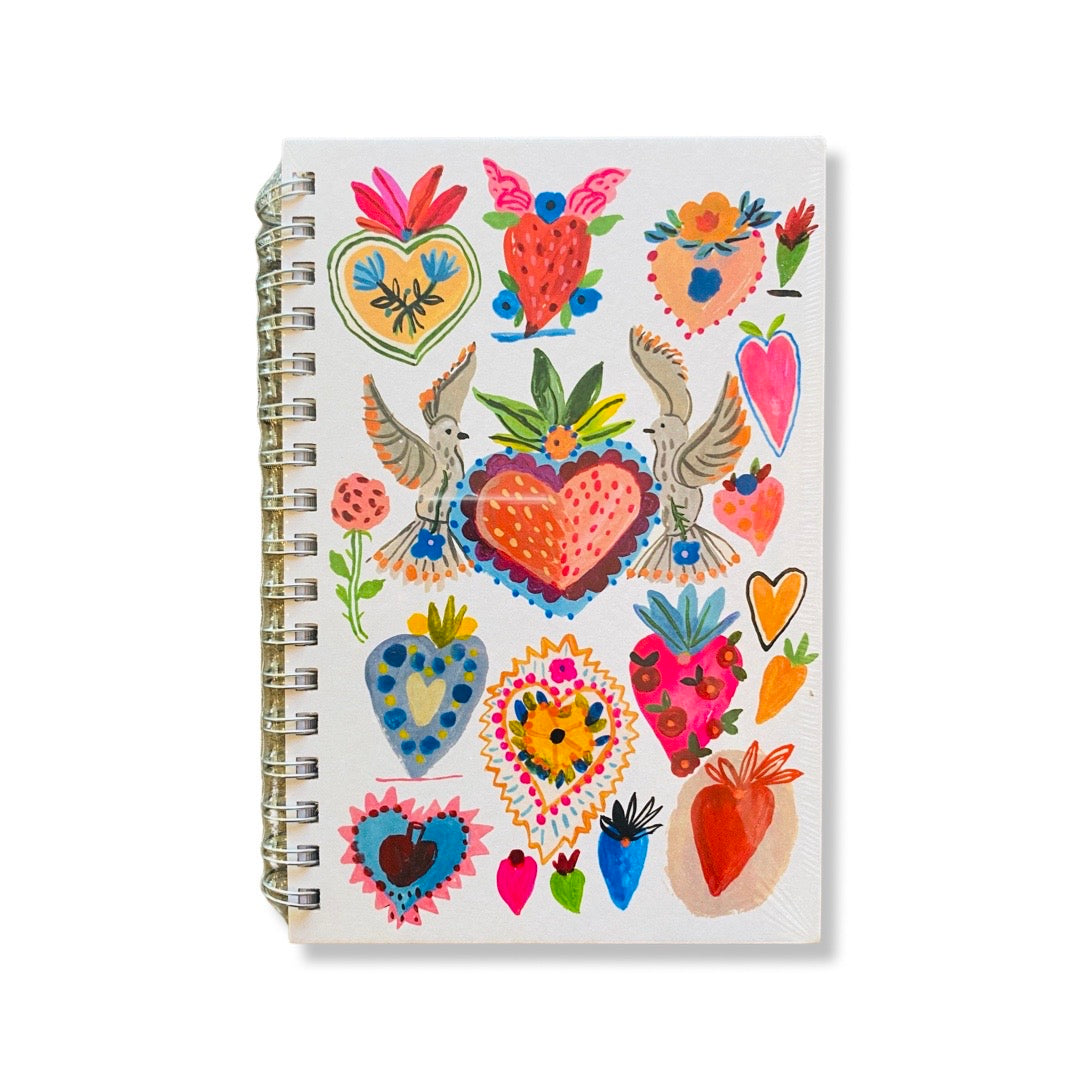 Sacred hearts journal. Design features different colored and sized hearts with doves in the middle.
