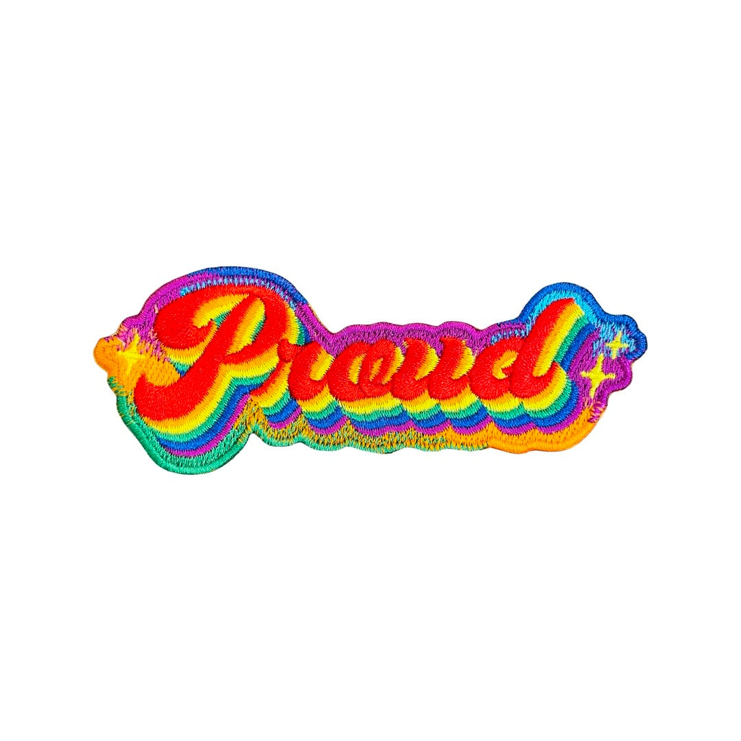 Rainbow patch that reads "Proud".