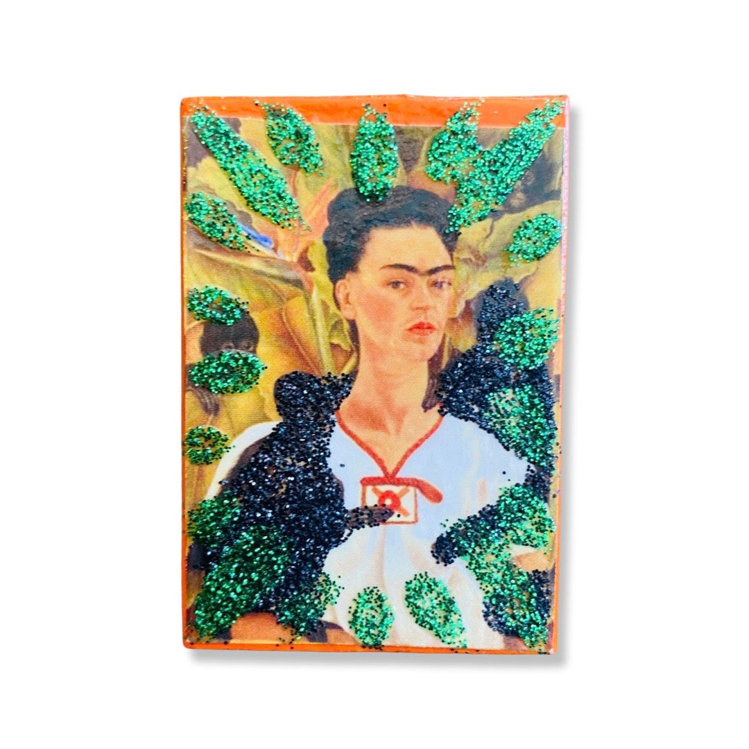 Frida Kahlo self-portrait match box with glitter accents. 