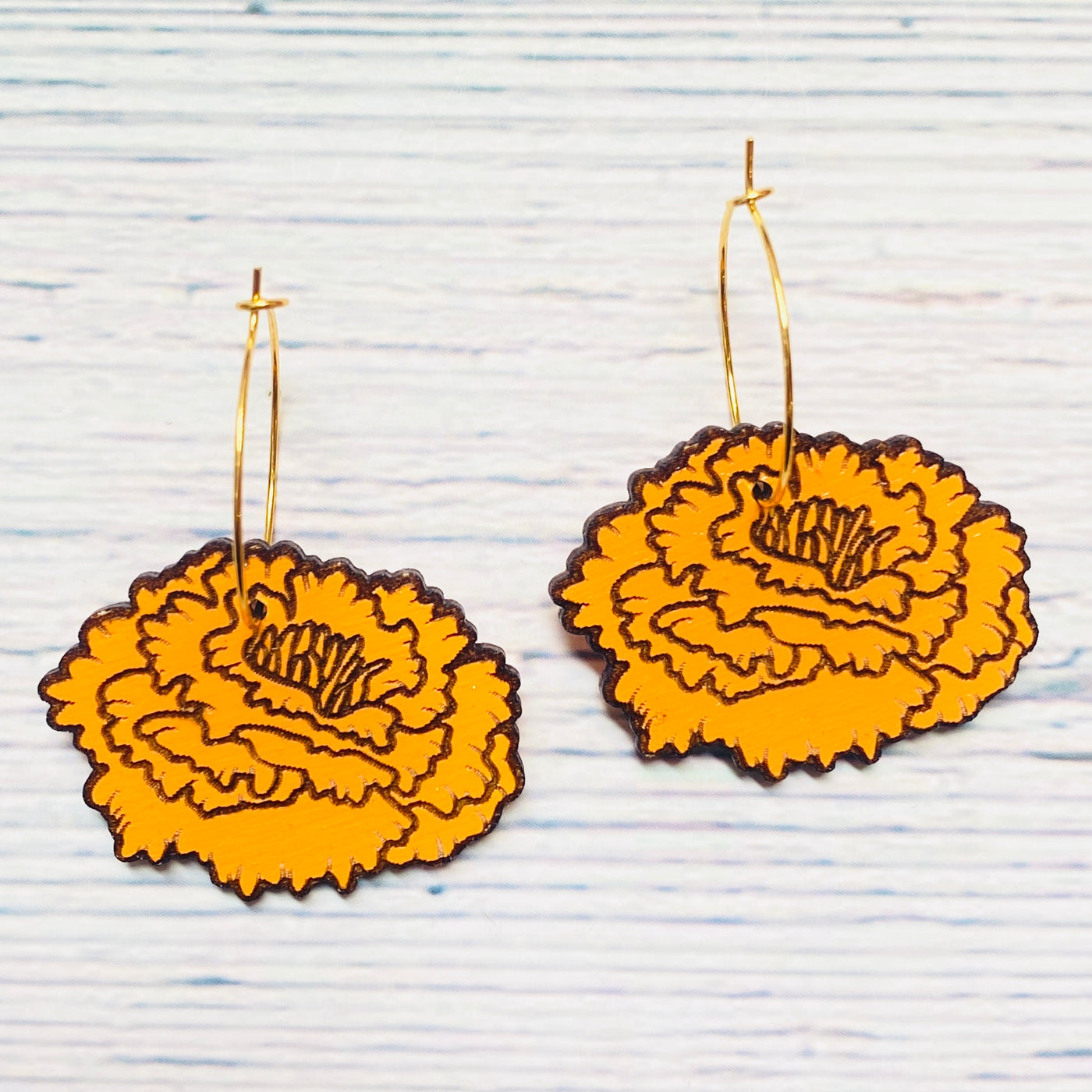 Marigold laser cut wood hoop earrings.