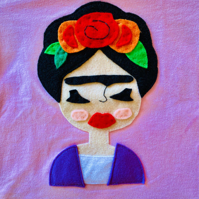 Close up of hand-stitched Frida kid's pink t-shirt.