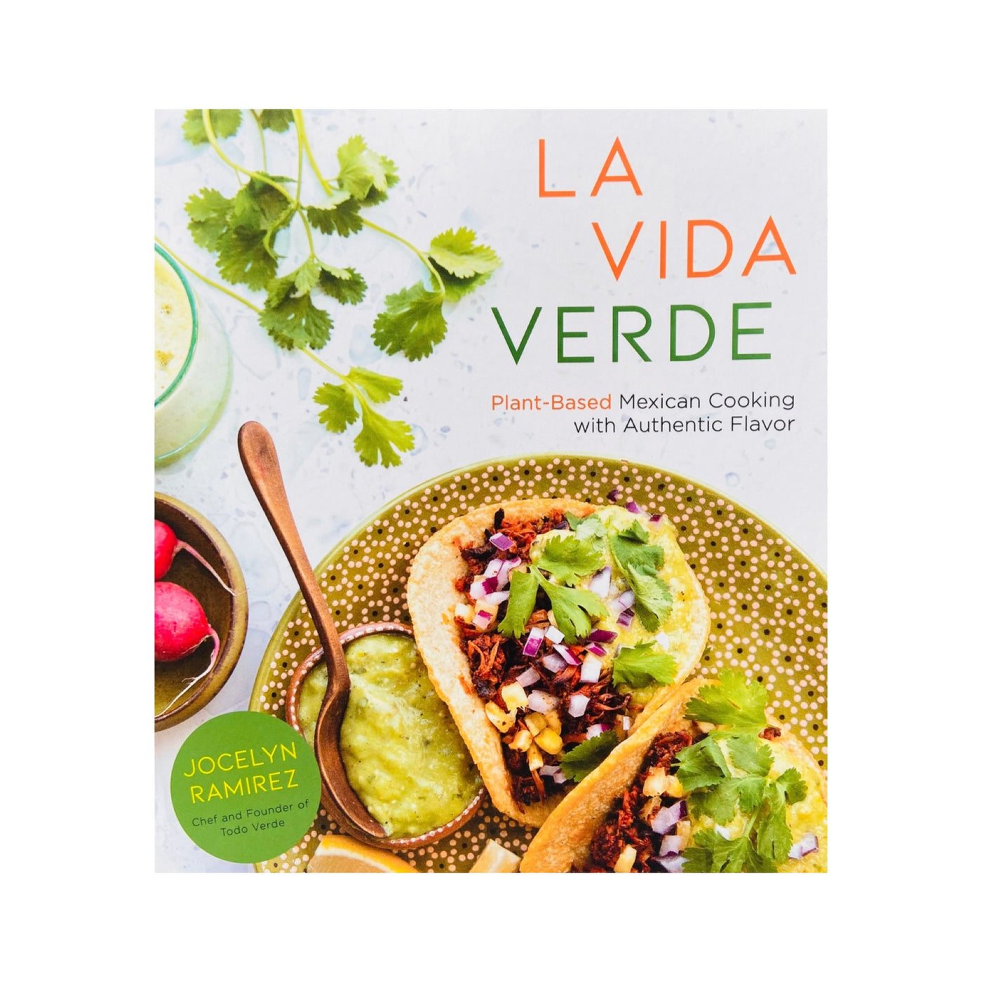 Front cover of La Vida Verde: Plant-Based Mexican Cooking with Authentic Flavor cookbook by Jocelyn Ramirez. Cover art features tacos on a green floral plate served with condiments (red onion, cilantro, radishes, salsa). 