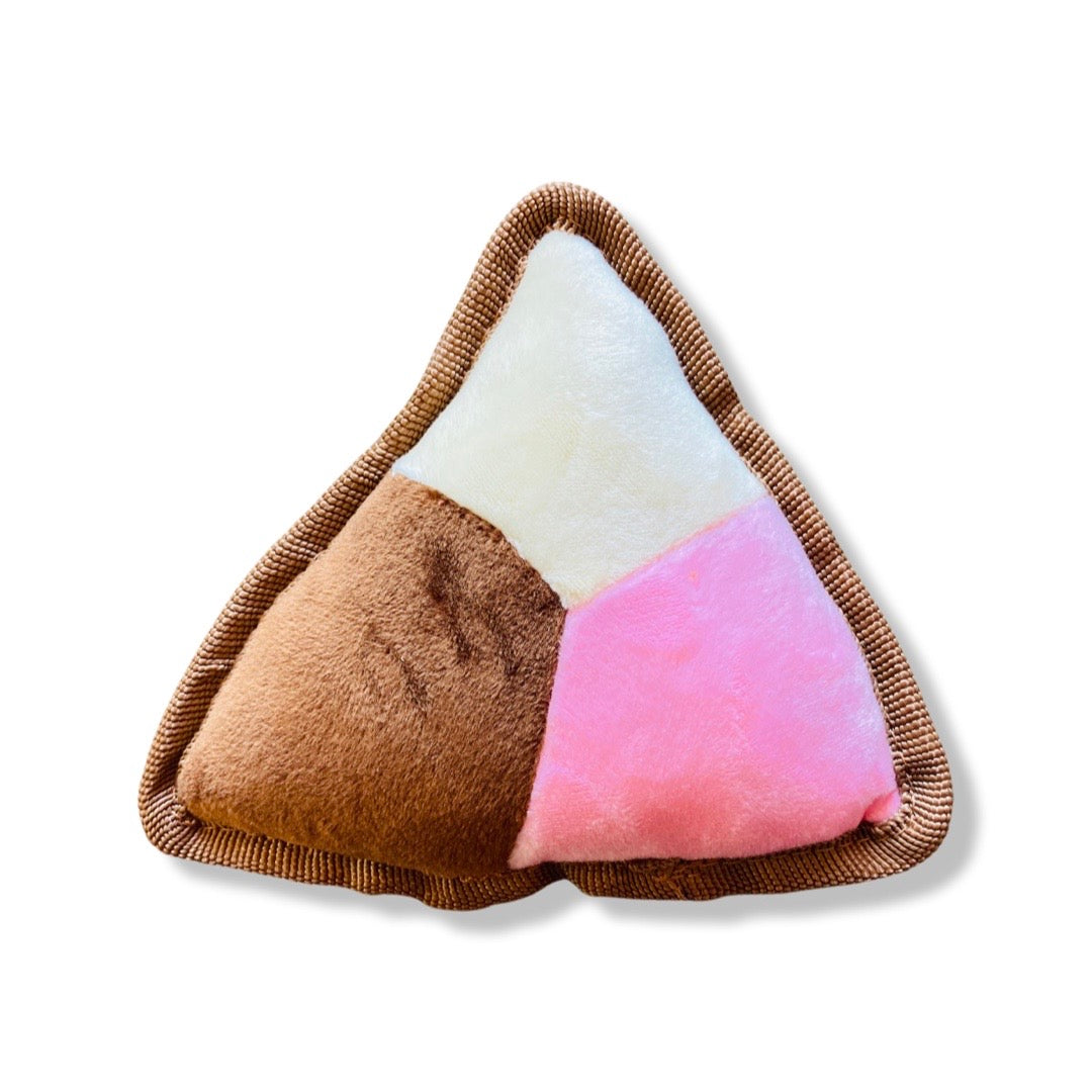 Plush squeaky triangle (type of sweet bread) dog toy. Colors featured: pink, white, and brown.