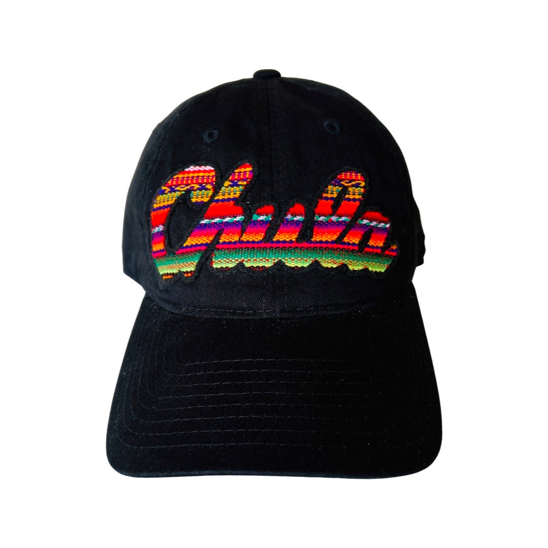 Black, "Chula" serape patterned phrase cap. 