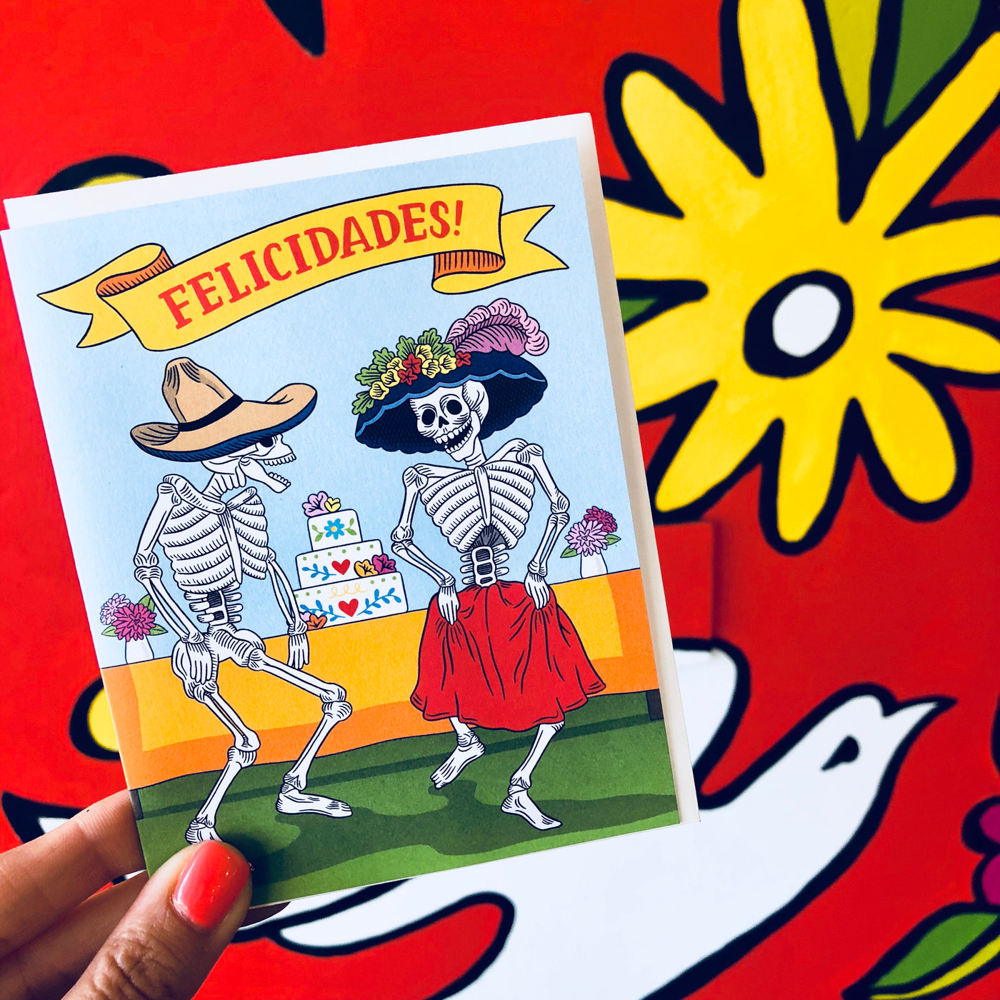 Felicidades Congratulations card are with two dancing skeletons in front of a wedding cake