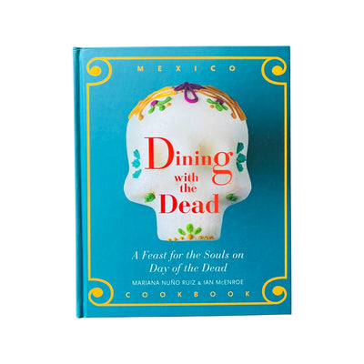 Book with a teal background and a sugar skull in the center with the title Dining with the Dead in red lettering.