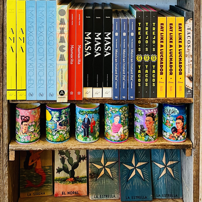 Photo of cookbooks & decorations on a wood shelf