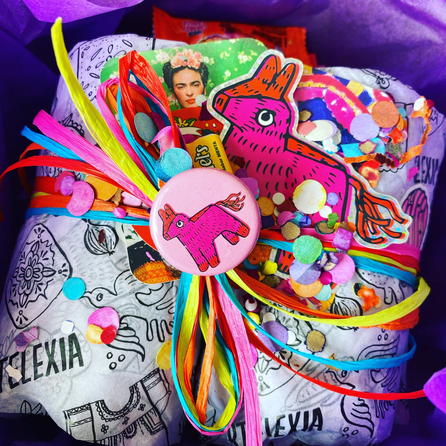 Photo of Artelexia product wrapped in Artelexia branded tissue paper and colorful ribbon