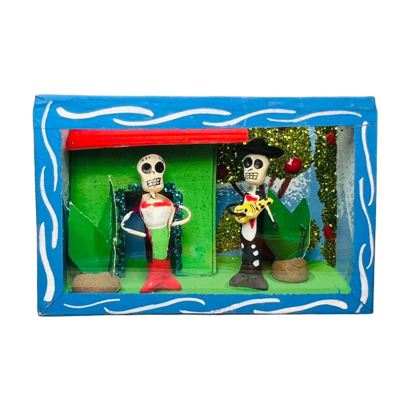 blue nicho box that features a scene with skeletons singing in front of a house