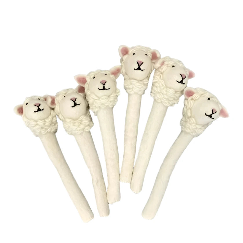 A set of six handmade felt sheep pencil toppers with soft white wool bodies, detailed embroidered faces, and curly textured fleece.