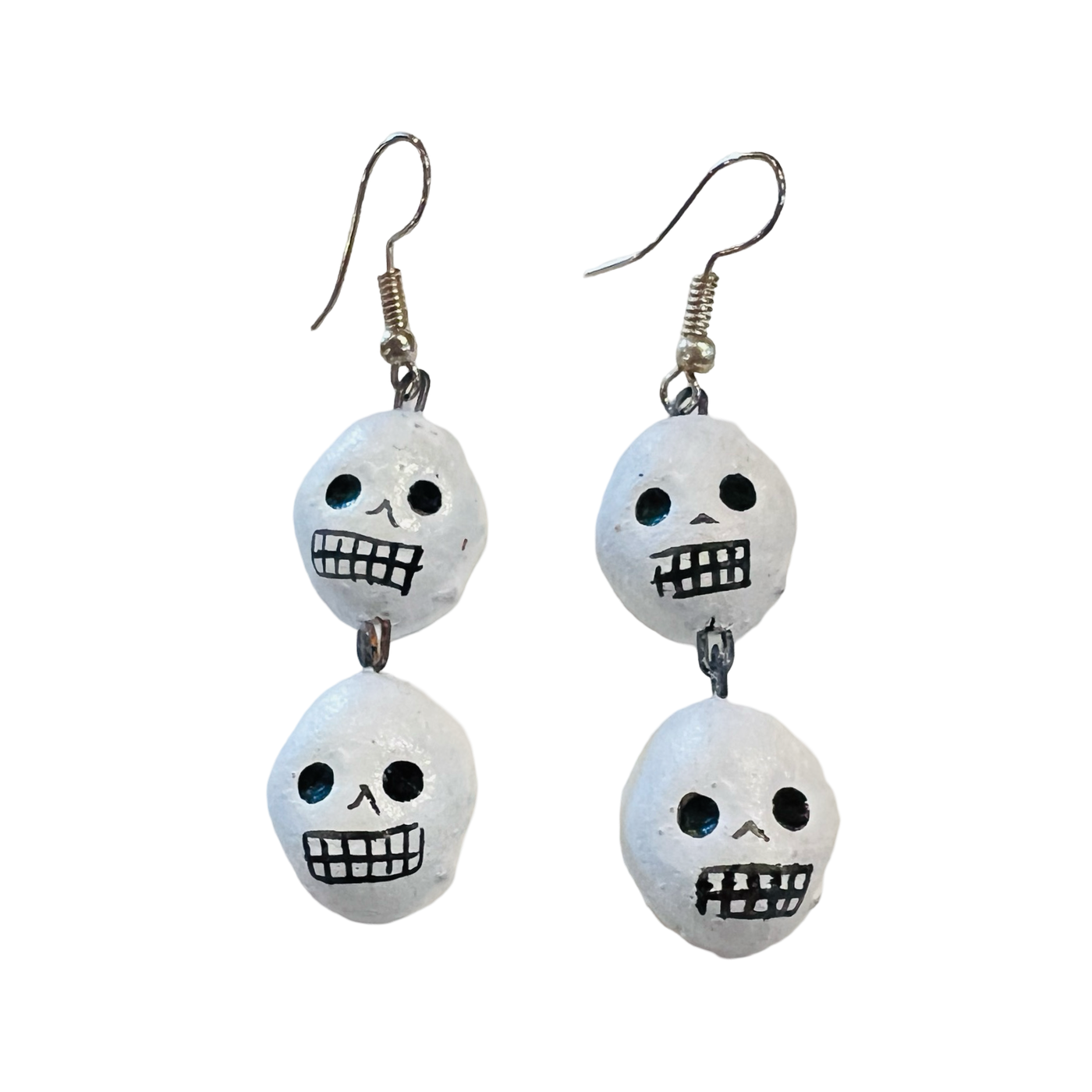 set of white clay skull earrings with each one having two skulls.