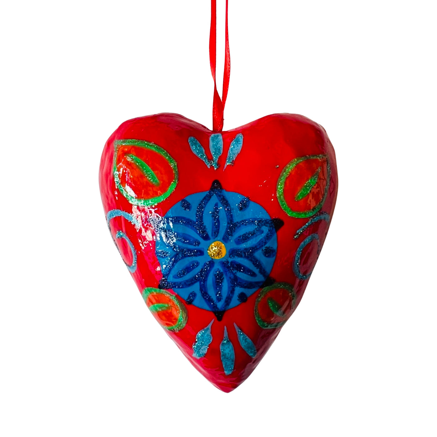 Red paper mache heart with a multi-colored design