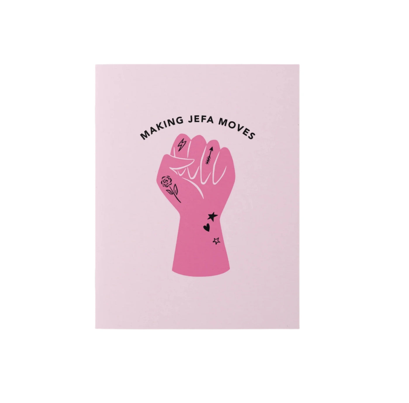 A pink pocket notepad with a graphic design of a raised fist featuring tattoo-inspired illustrations like a rose, stars, and an arrow. The text above reads "Making Jefa Moves," celebrating empowerment and ambition.