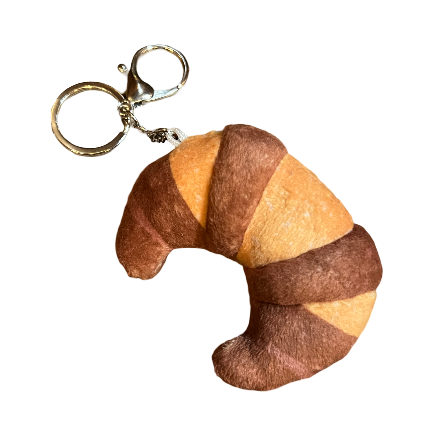 light and dark brown croissant (cuerno) plush keychain with a silver ring.