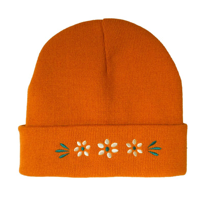 light orange beanie with a embroidered barro floral design.