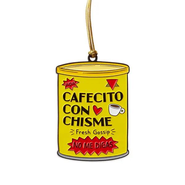 A yellow enamel ornament shaped like a coffee can with the text "Cafecito con Chisme – Fresh Gossip" and "No Me Digas," featuring playful red and black accents, a coffee cup illustration, and a gold hanging cord.