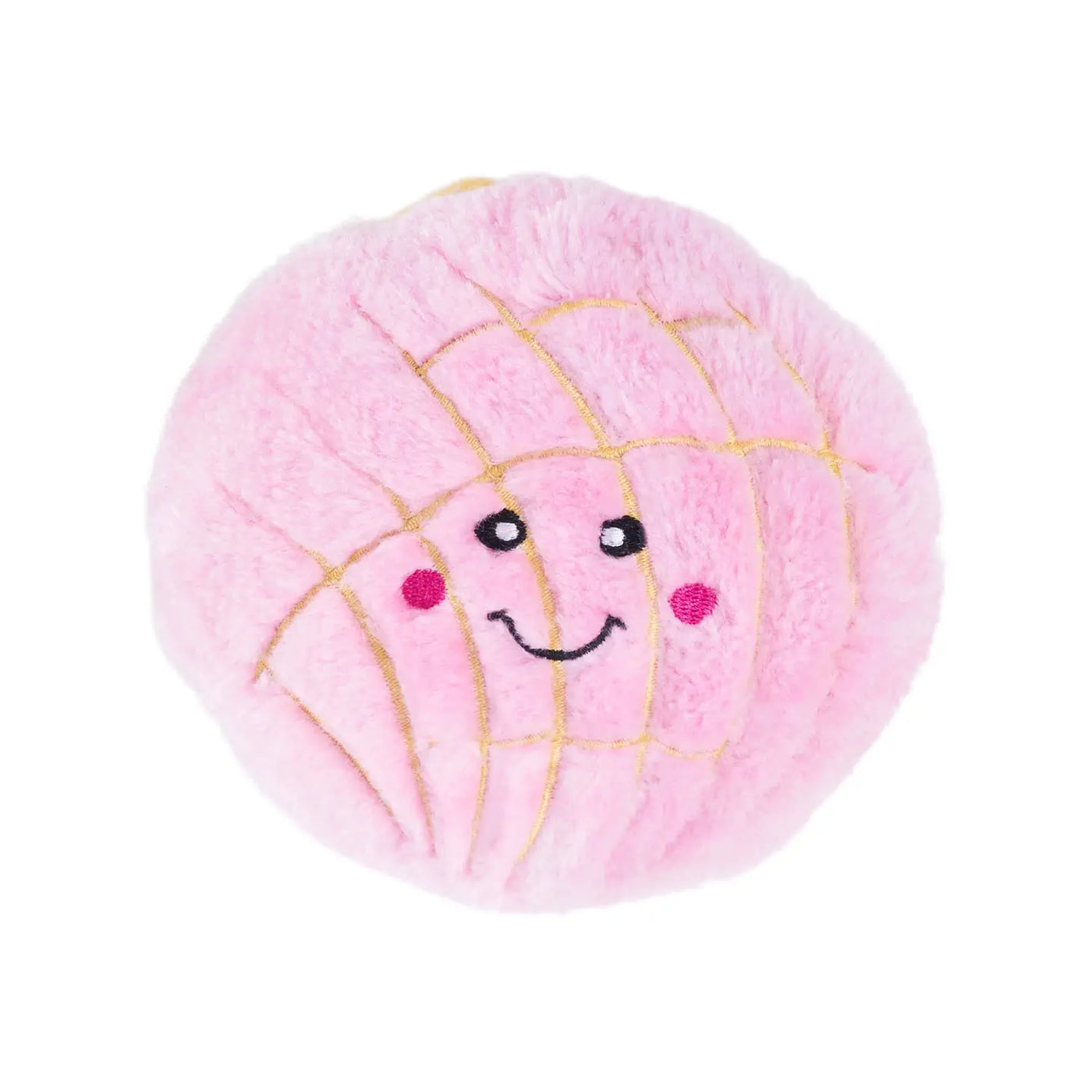 A pink pan dulce concha dog toy featuring a soft, plush texture with embroidered details. The toy has a smiling face with rosy cheeks and golden stitching that mimics the iconic shell pattern of a concha.