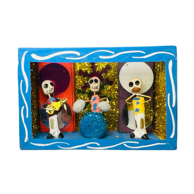 blue nicho box that features a scene with skeletons playing instruments