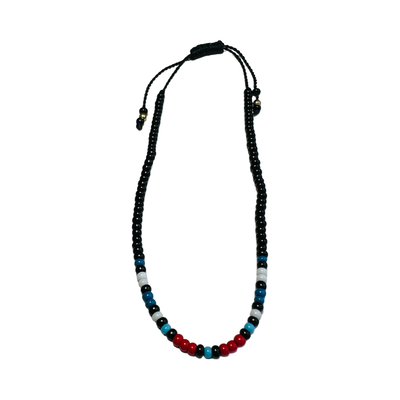 Vibrant Mexican bead bracelet featuring blue, red, black, and white beads.