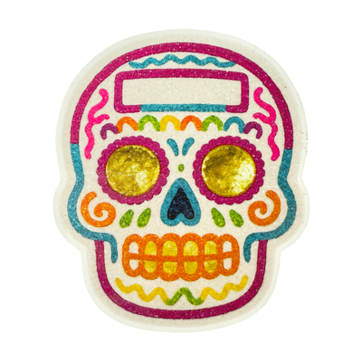 Colorful Día de Muertos sugar skull sticker with golden eyes, bright orange teeth, and decorative patterns in pink, teal, green, and yellow.