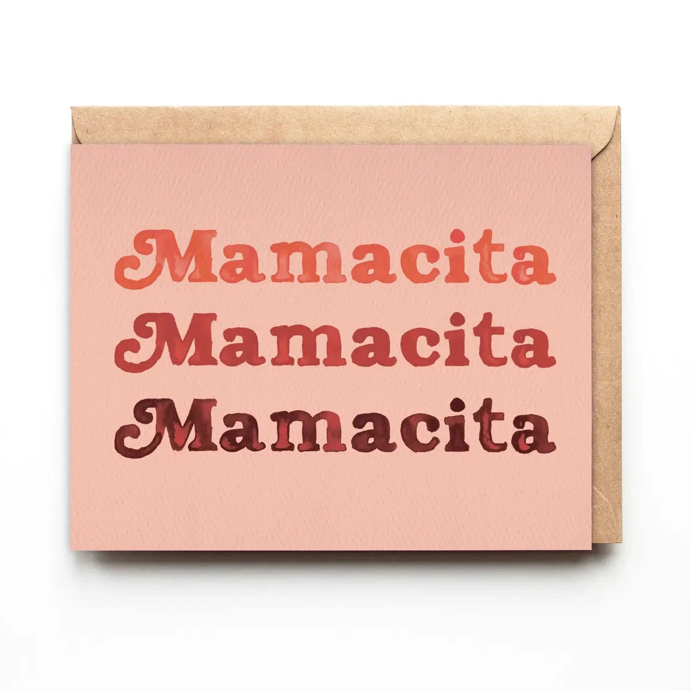 light coral greeting card with a brown envelope and the word Mamacita three times in different shades of pink/maroon colors.