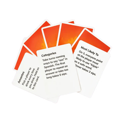 A fan of Tragos Espicy expansion pack cards displayed on a purple background, featuring white cards with bilingual prompts like "Categories" and "Most Likely To," alongside orange-backed cards with flame designs.