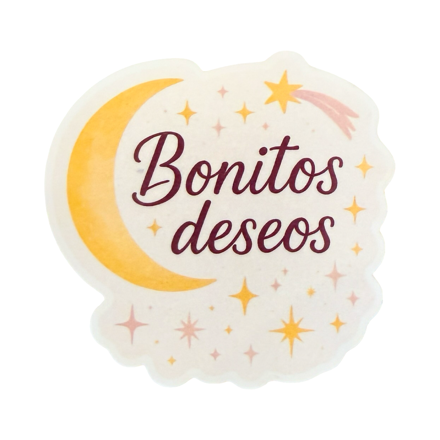 Sticker with the phrase "Bonitos deseos" in burgundy script, surrounded by a yellow crescent moon, stars, and sparkles on a soft cream background.