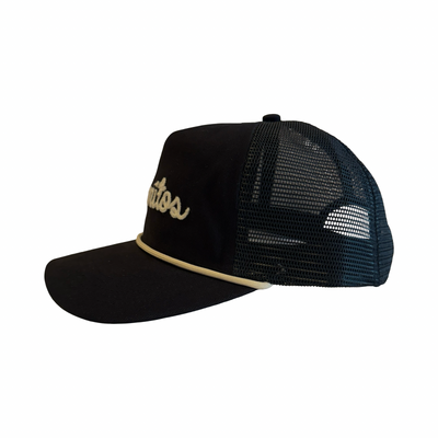side view of a Black hat with the word “Burritos” embroidered in white script on the front.