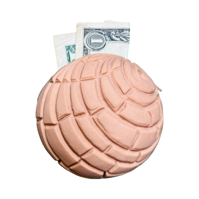 round rubber brown concha coin purse with a dollar bill