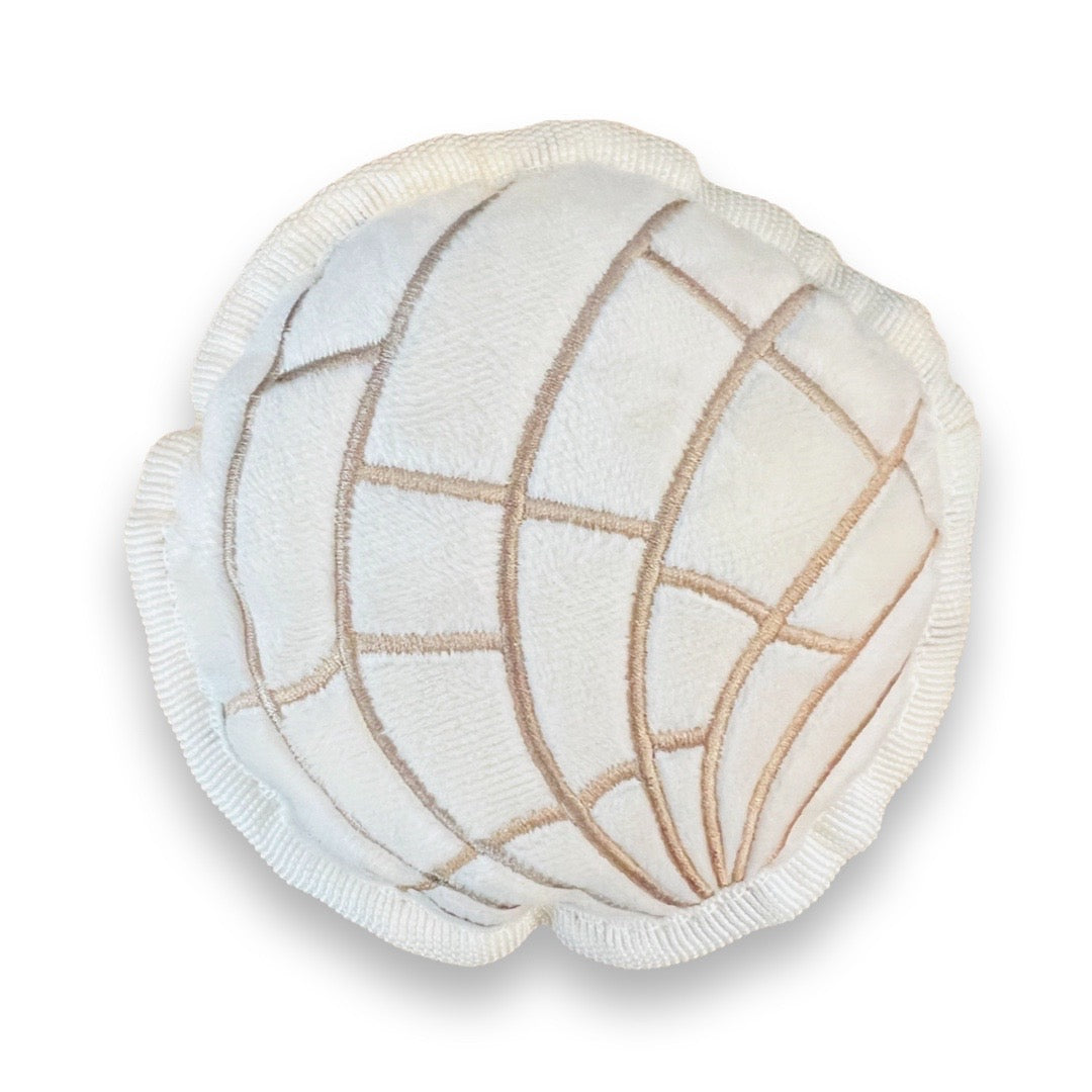 Cream colored round concha (sweet bread) dog toy.