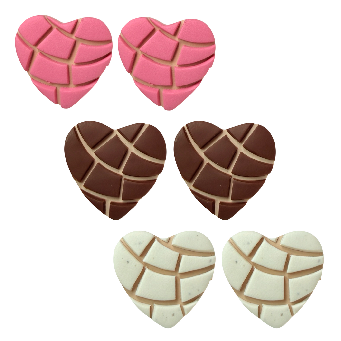 Heart-shaped candies with concha patterns in pink, brown, and white on a white background