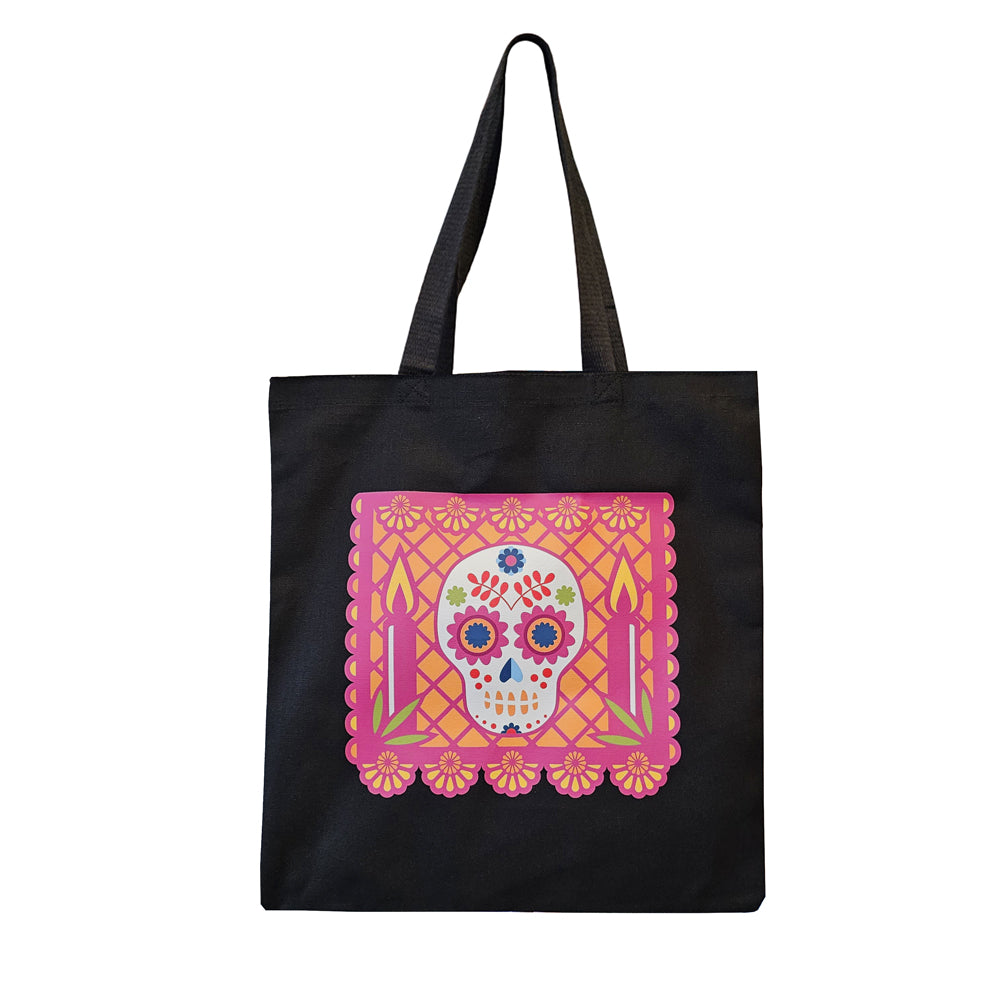 Black canvas tote bag featuring berry colored papel picado banner with a sugar skull & candles