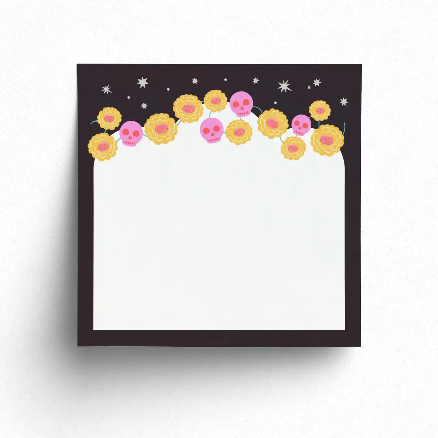 Sticky note pad with a black border decorated with yellow marigolds, pink calaveras, and white stars across the top.